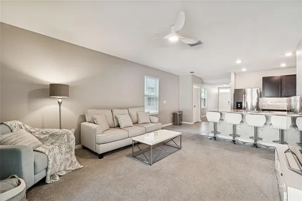 a living room with furniture and a lamp