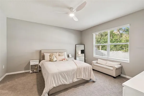 a bedroom with a bed couch and window