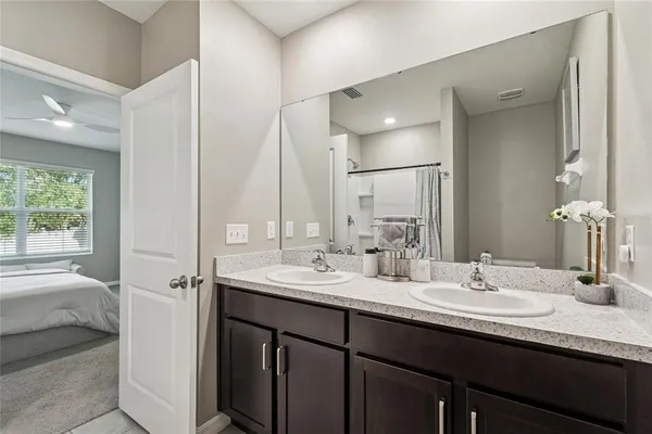 a bathroom with double vanity sinks and a mirror