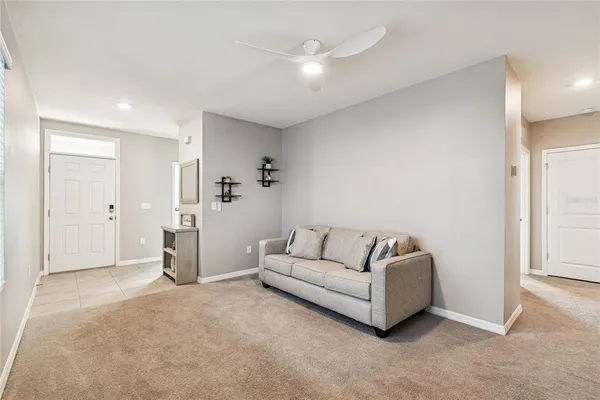 a living room with furniture and a white wall