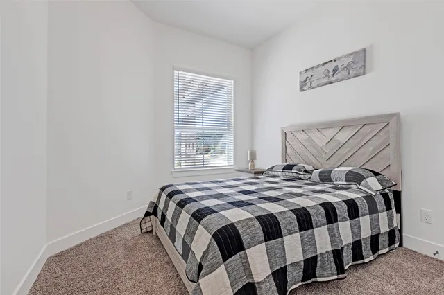 a view of a room with wooden floor and a bathroom