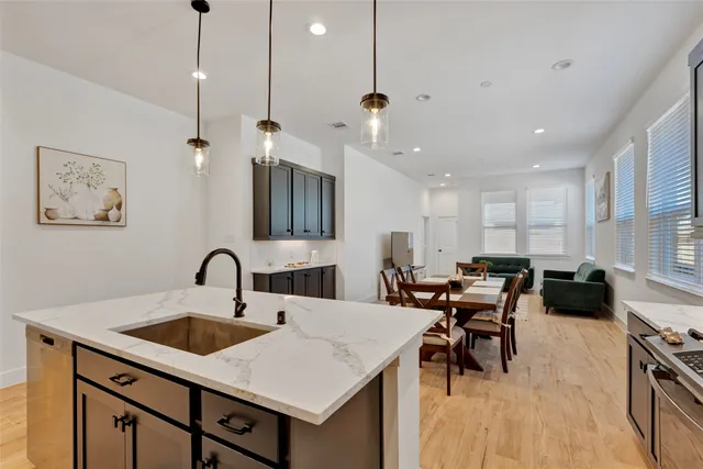 a view of a a dining room with furniture window and wooden floor