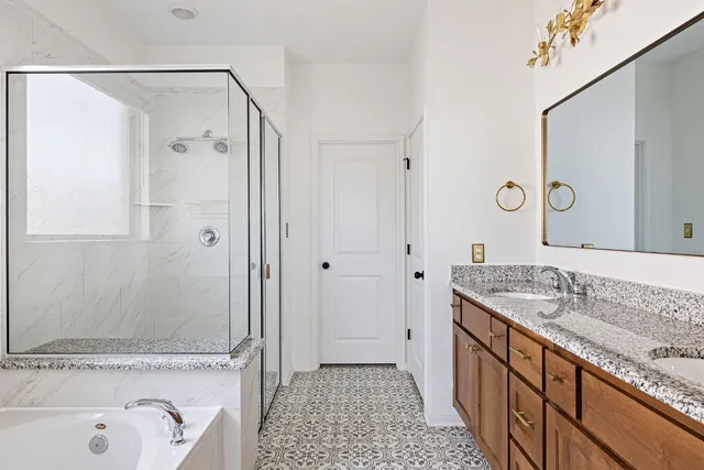 a bathroom with a granite countertop sink a mirror and a bathtub