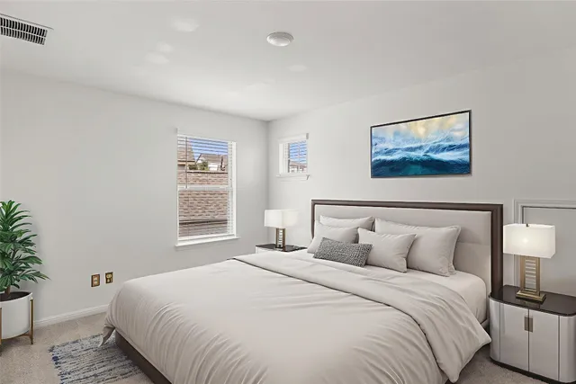 a bedroom with a bed and a painting on the wall