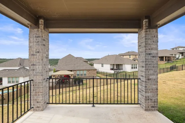 a view of a balcony with a floor to ceiling window and wooden fence