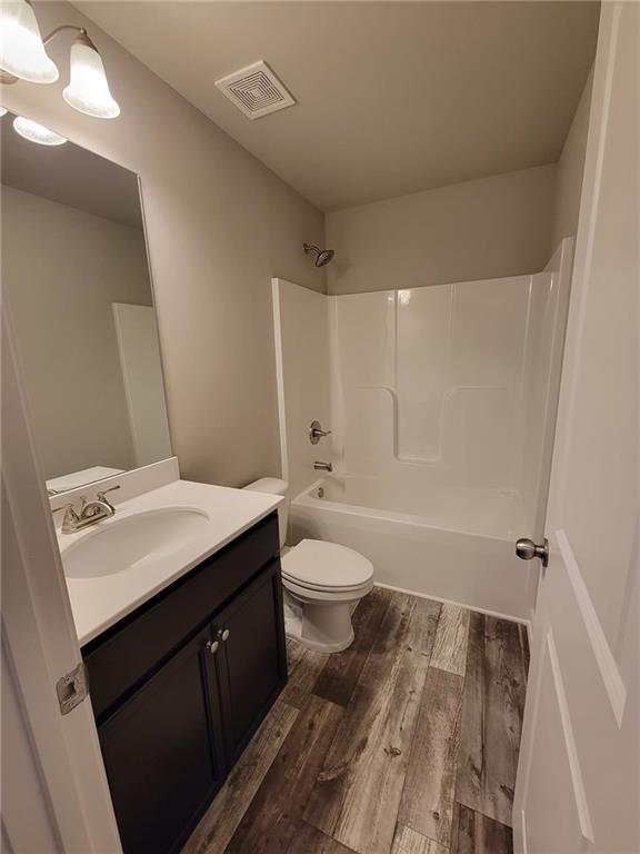 5205 Fox Den Road Oakwood, GA 30566 - Photo 16 of 19 a bathroom with a sink a toilet and shower