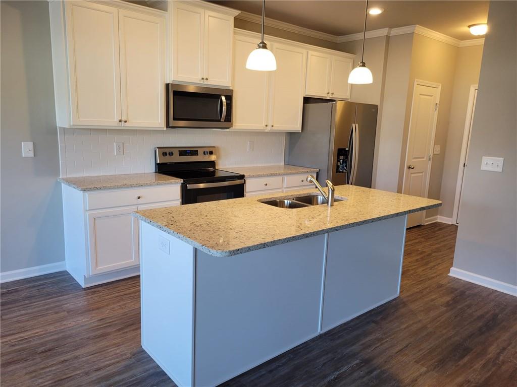 5205 Fox Den Road Oakwood, GA 30566 - Photo 7 of 19 a kitchen with wooden cabinets and a sink