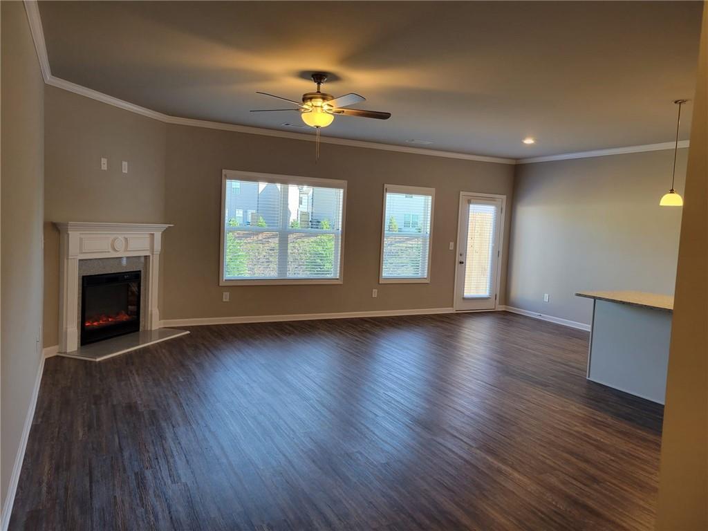 5205 Fox Den Road Oakwood, GA 30566 - Photo 10 of 19 an empty room with wooden floor fireplace and windows