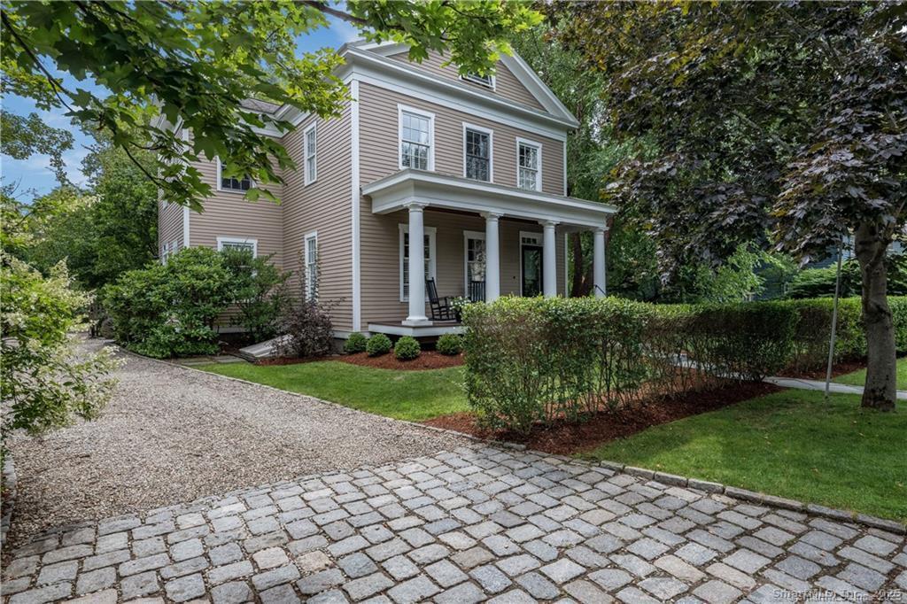 a front view of a house with garden