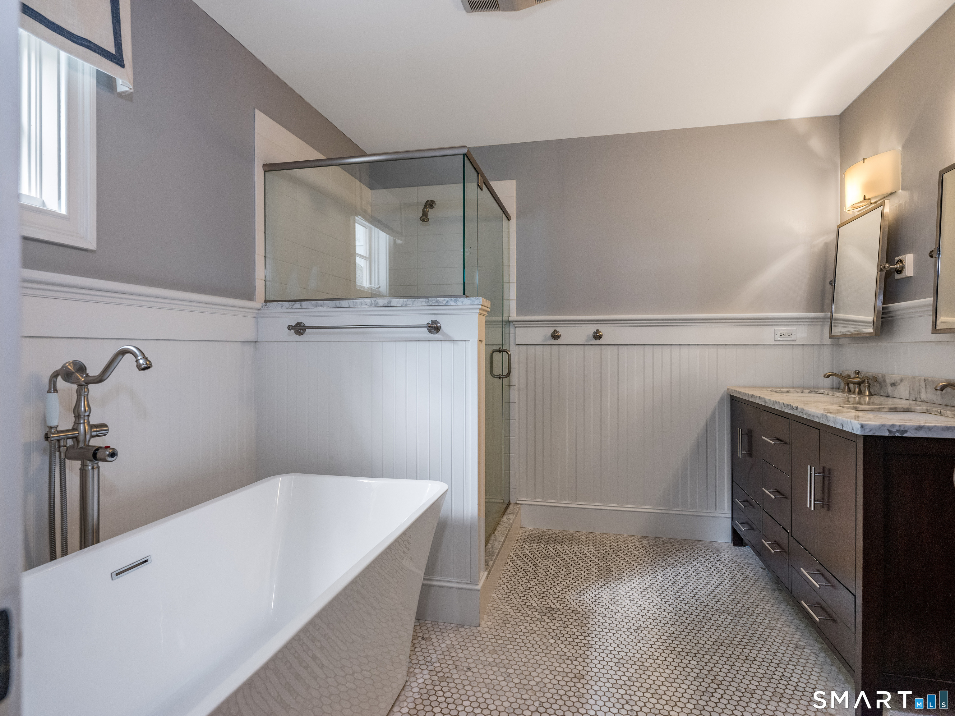 63 Broad Street Guilford, CT 06437 - Photo 18 of 40 a bathroom with a granite countertop sink a toilet and shower