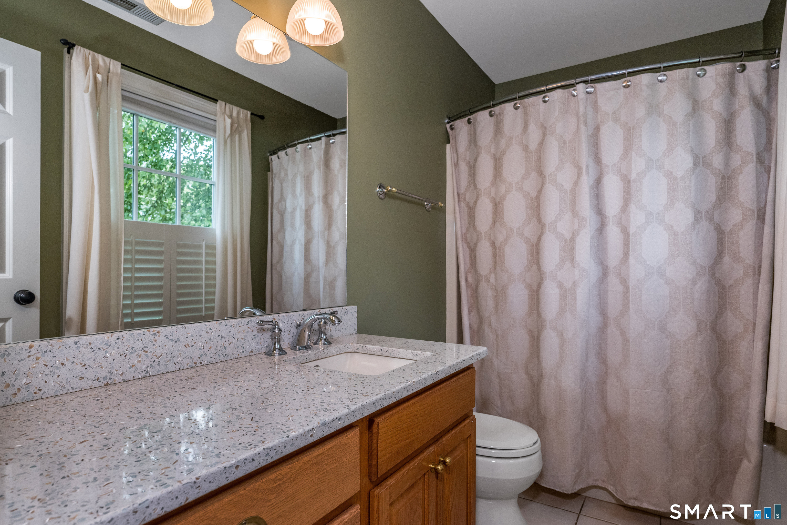 63 Broad Street Guilford, CT 06437 - Photo 21 of 40 a bathroom with a granite countertop sink and a mirror