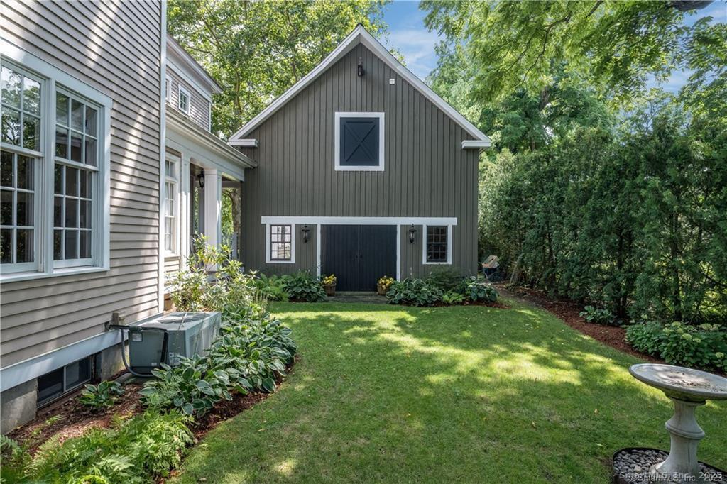 63 Broad Street Guilford, CT 06437 - Photo 23 of 40 a view of a house with yard and plants