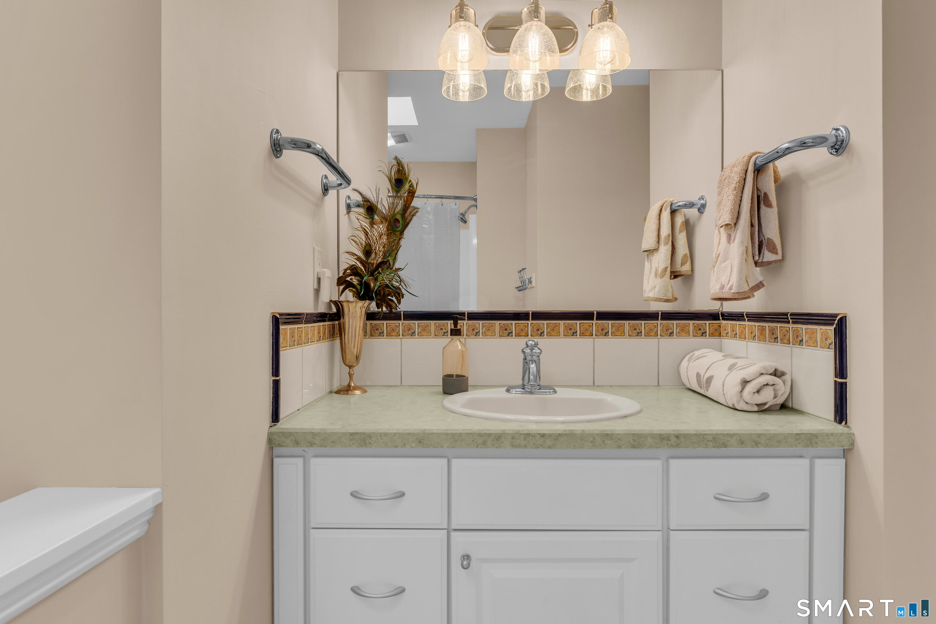 63 Broad Street Guilford, CT 06437 - Photo 26 of 40 a bathroom with a sink and a mirror
