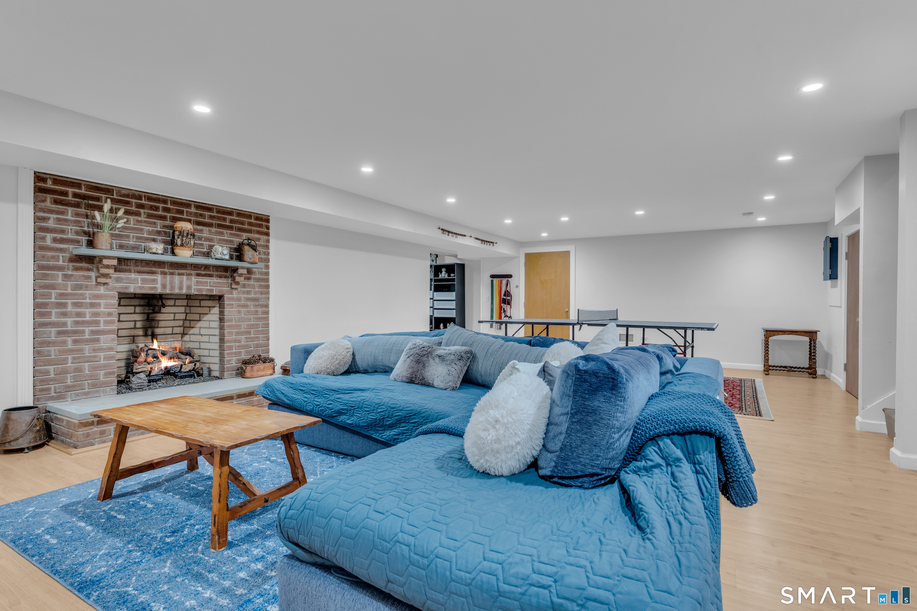 63 Broad Street Guilford, CT 06437 - Photo 27 of 40 a living room with furniture and a fireplace
