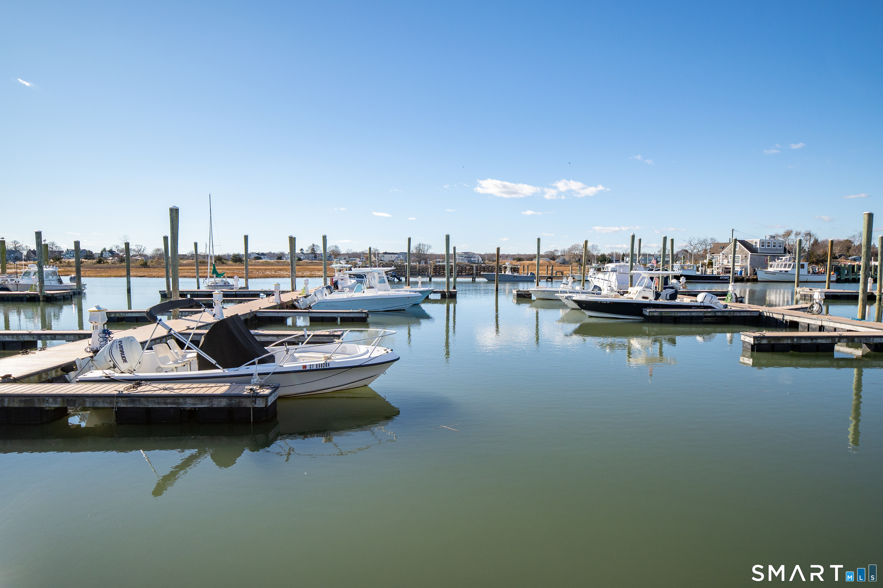 63 Broad Street Guilford, CT 06437 - Photo 37 of 40 a view of a lake with boats and trees in the background