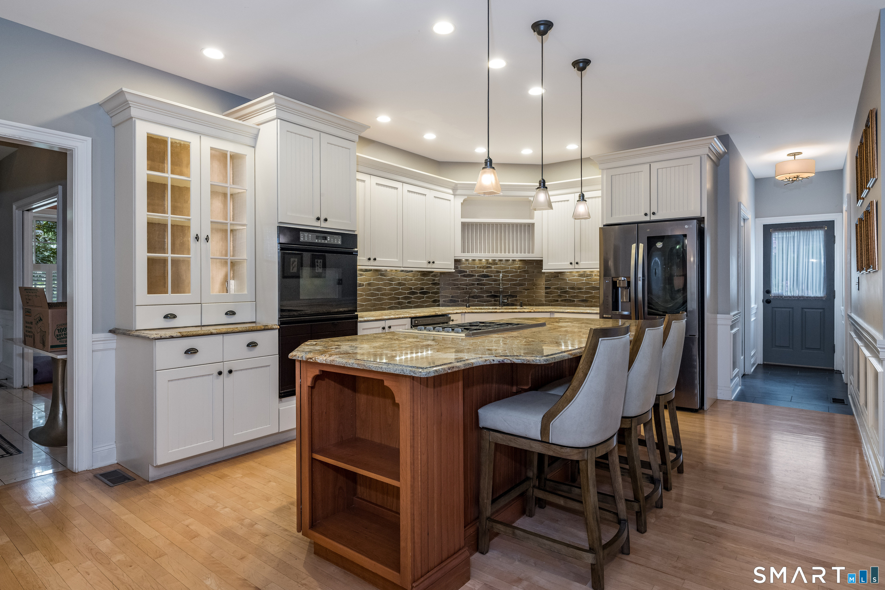 63 Broad Street Guilford, CT 06437 - Photo 5 of 40 a kitchen with kitchen island granite countertop a sink and refrigerator