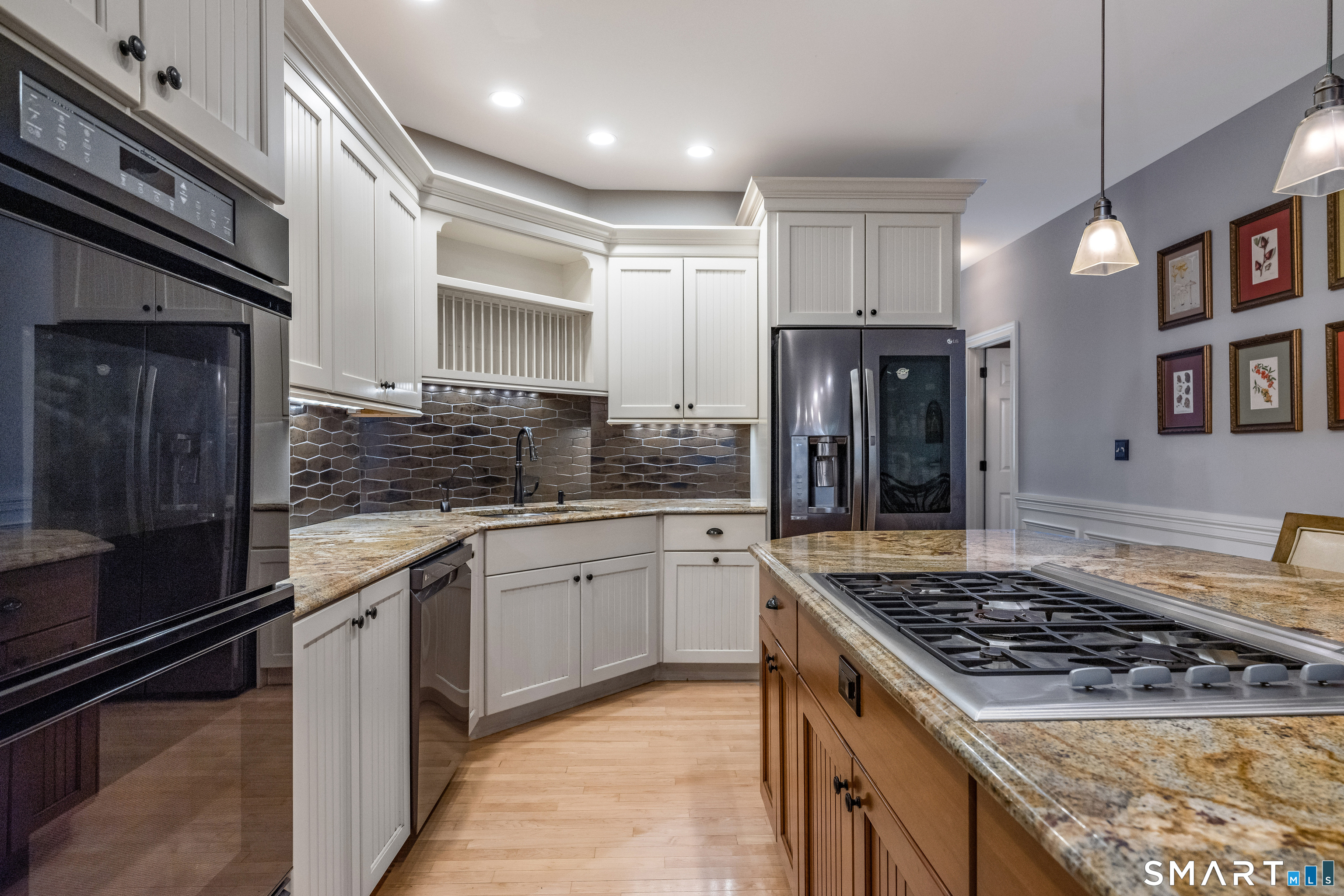 63 Broad Street Guilford, CT 06437 - Photo 6 of 40 a kitchen with stainless steel appliances granite countertop a stove sink and cabinets