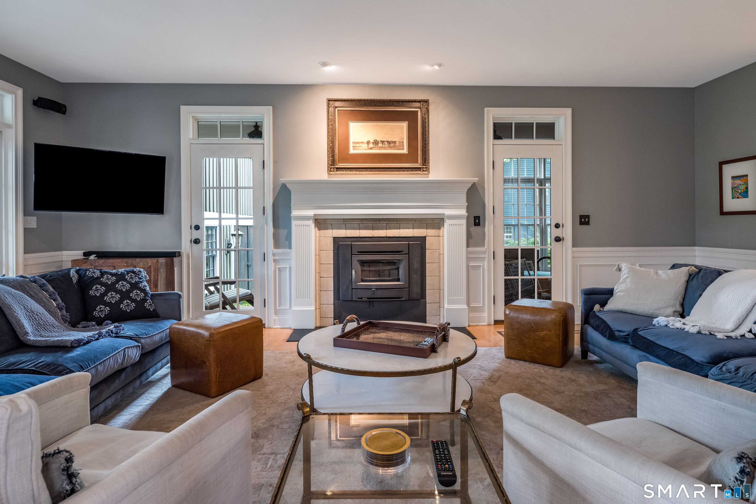 63 Broad Street Guilford, CT 06437 - Photo 10 of 40 a living room with furniture a fireplace and a flat screen tv