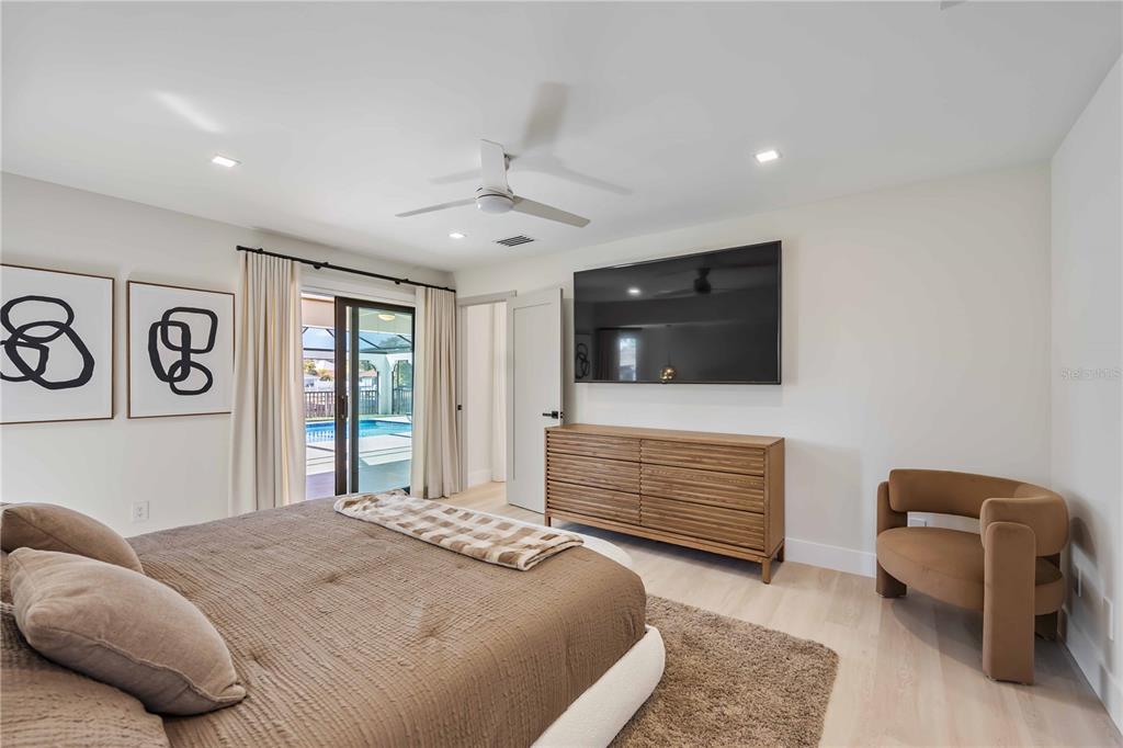 105 Sinclair Street Southeast Port Charlotte, FL 33952 - Photo 25 of 69 a bedroom with a bed and a television