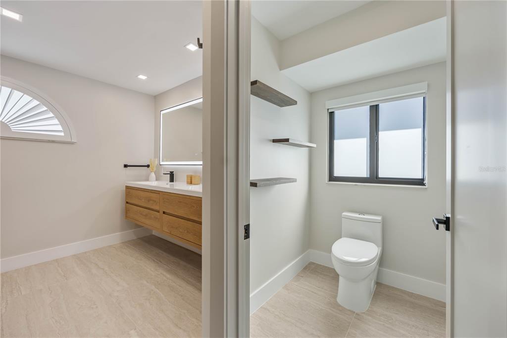 105 Sinclair Street Southeast Port Charlotte, FL 33952 - Photo 29 of 69 a bathroom with a sink a toilet and shower