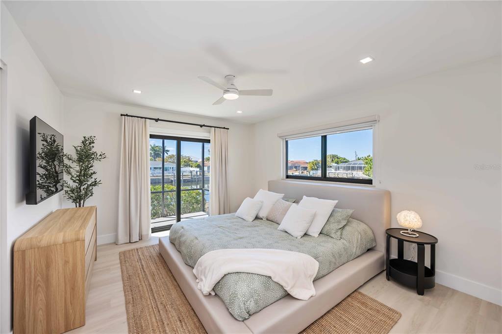 105 Sinclair Street Southeast Port Charlotte, FL 33952 - Photo 30 of 69 a bedroom with a large bed and a window