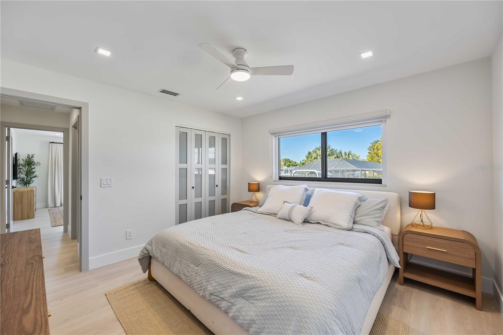 105 Sinclair Street Southeast Port Charlotte, FL 33952 - Photo 34 of 69 a bedroom with a large bed and a painting on the wall