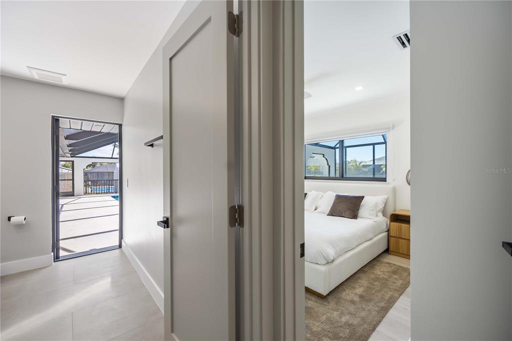 105 Sinclair Street Southeast Port Charlotte, FL 33952 - Photo 36 of 69 a bedroom with a bed and a large window