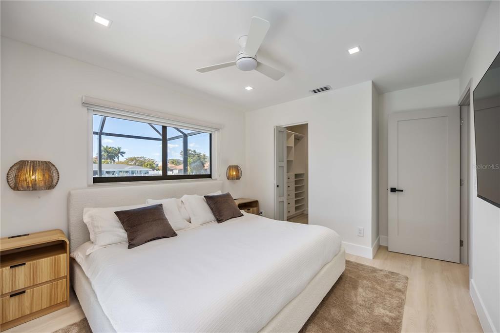 105 Sinclair Street Southeast Port Charlotte, FL 33952 - Photo 40 of 69 a bedroom with a large bed and a large window