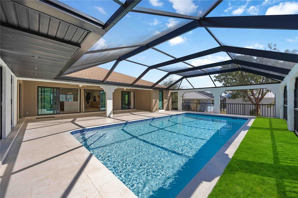 105 Sinclair Street Southeast Port Charlotte, FL 33952 - Photo 51 of 69 a view of a backyard with table and chairs under an umbrella