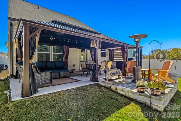 a front view of a house with outdoor seating
