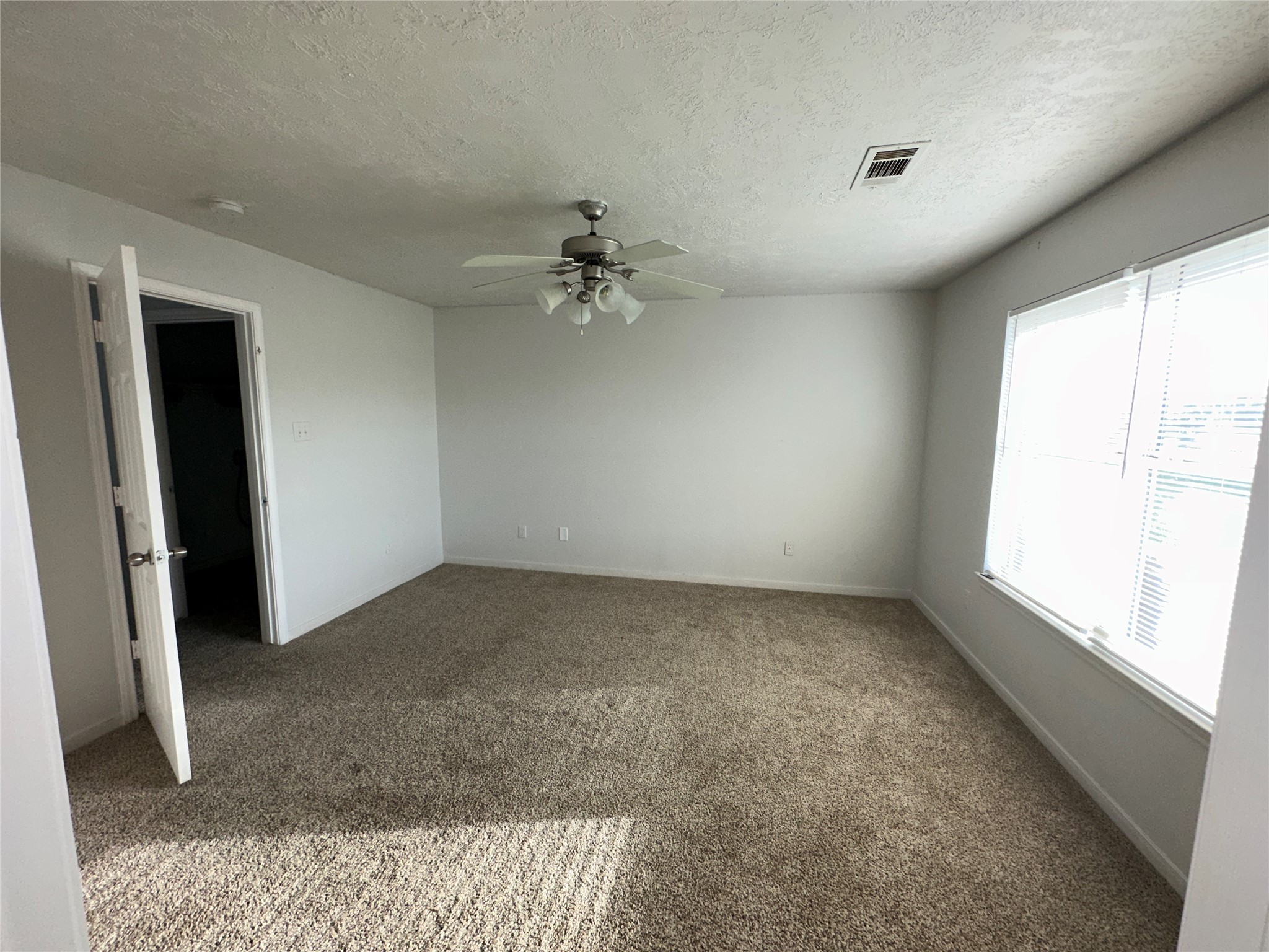 15931 Winston Point Lane Houston, TX 77084 - Photo 14 of 26 wooden floor in an empty room with a window