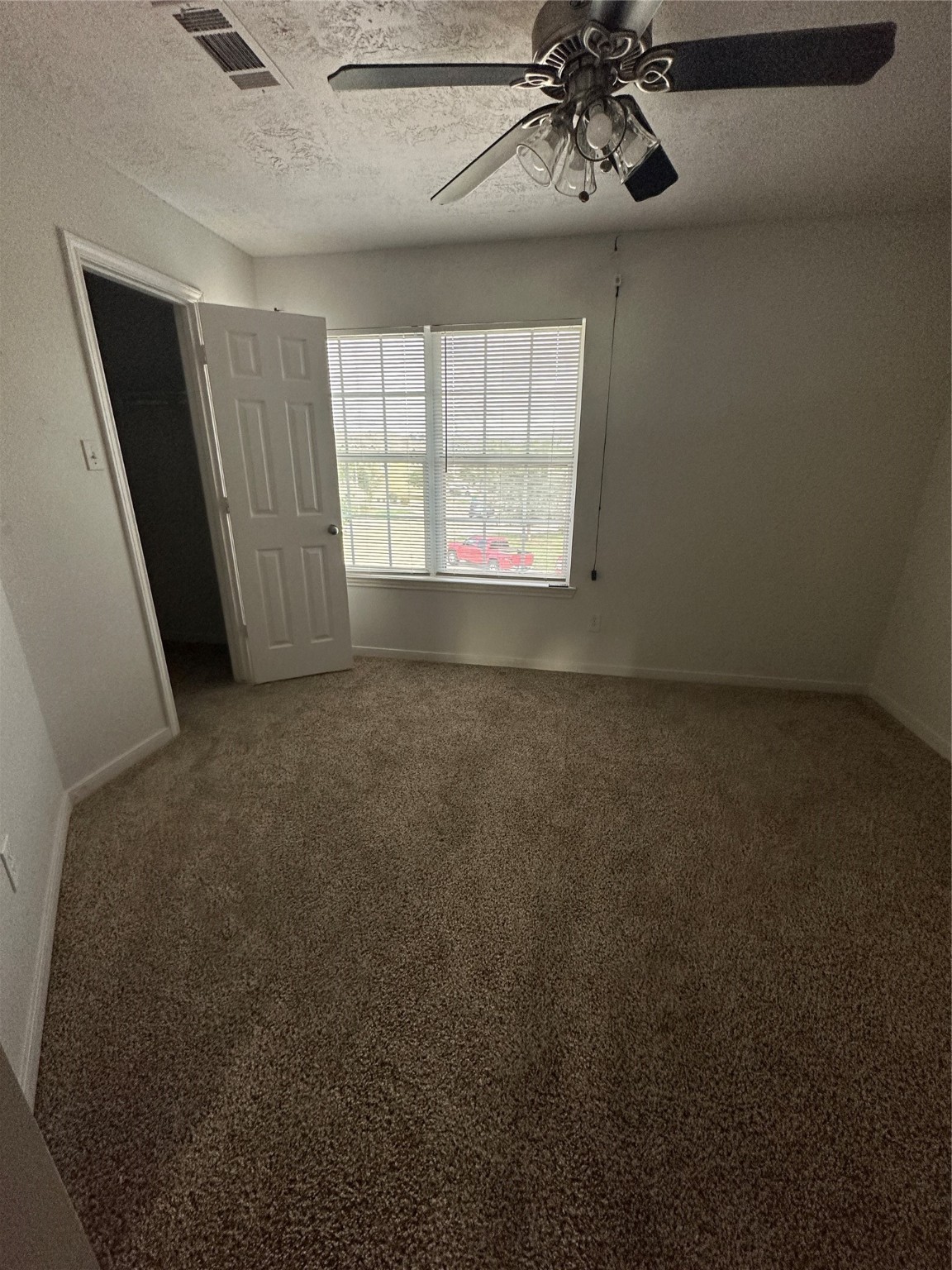 15931 Winston Point Lane Houston, TX 77084 - Photo 19 of 26 en empty room with windows and chandelier fan