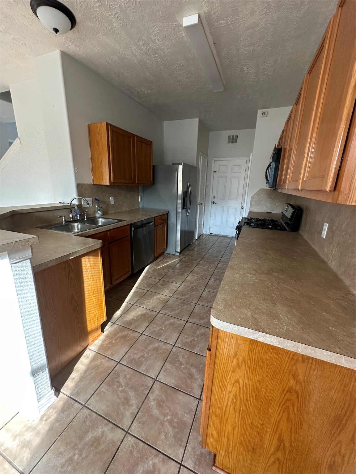 15931 Winston Point Lane Houston, TX 77084 - Photo 4 of 26 a kitchen with stainless steel appliances granite countertop a sink and stove