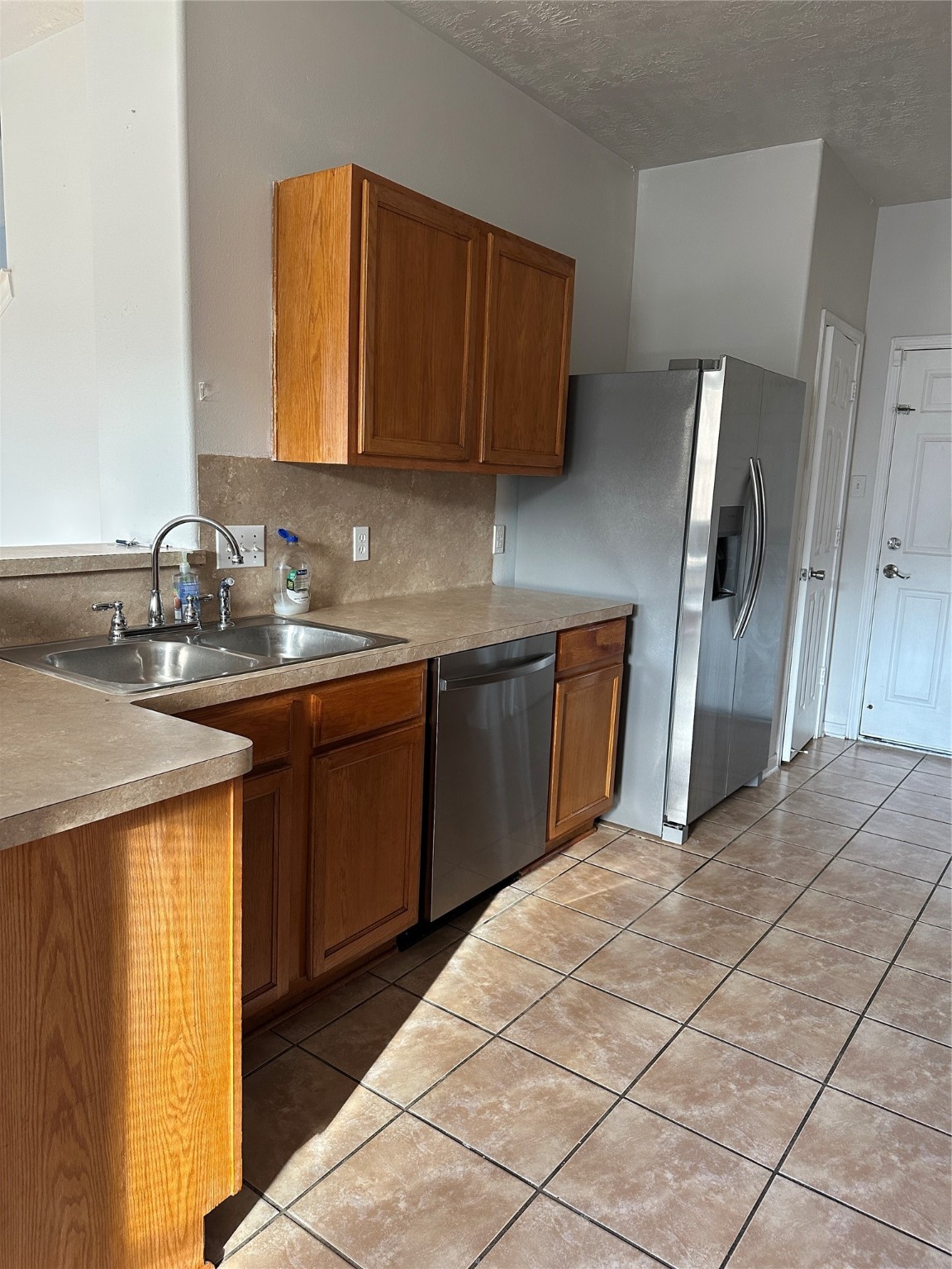 15931 Winston Point Lane Houston, TX 77084 - Photo 5 of 26 a kitchen with stainless steel appliances a sink stove and refrigerator