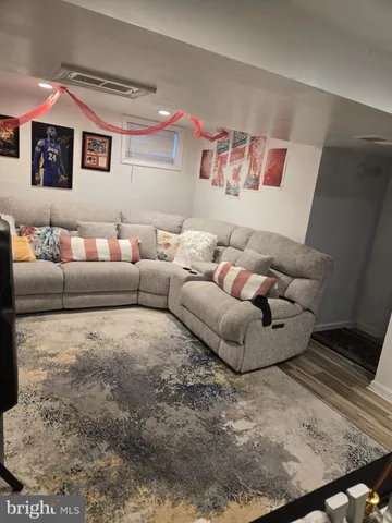 a living room with furniture and painting on the wall