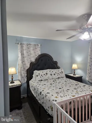 a bedroom with a bed and a lamp