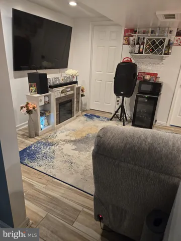 a living room with a flat screen tv and a fireplace