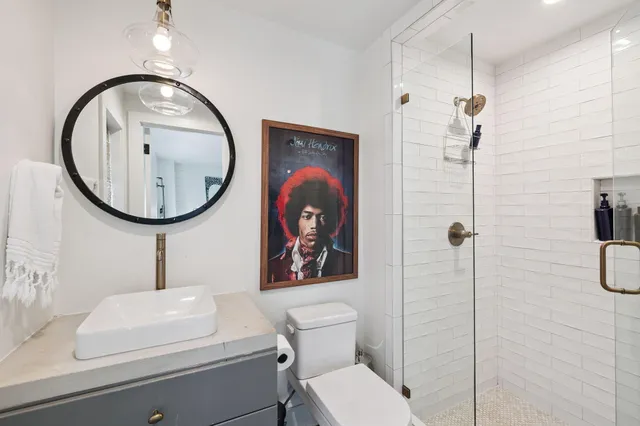 a utility room with dryer washer and a view of living room