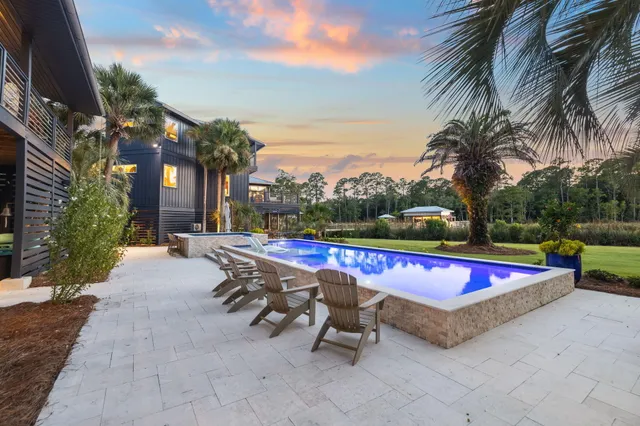 a view of a lake with a house swimming pool and outdoor space