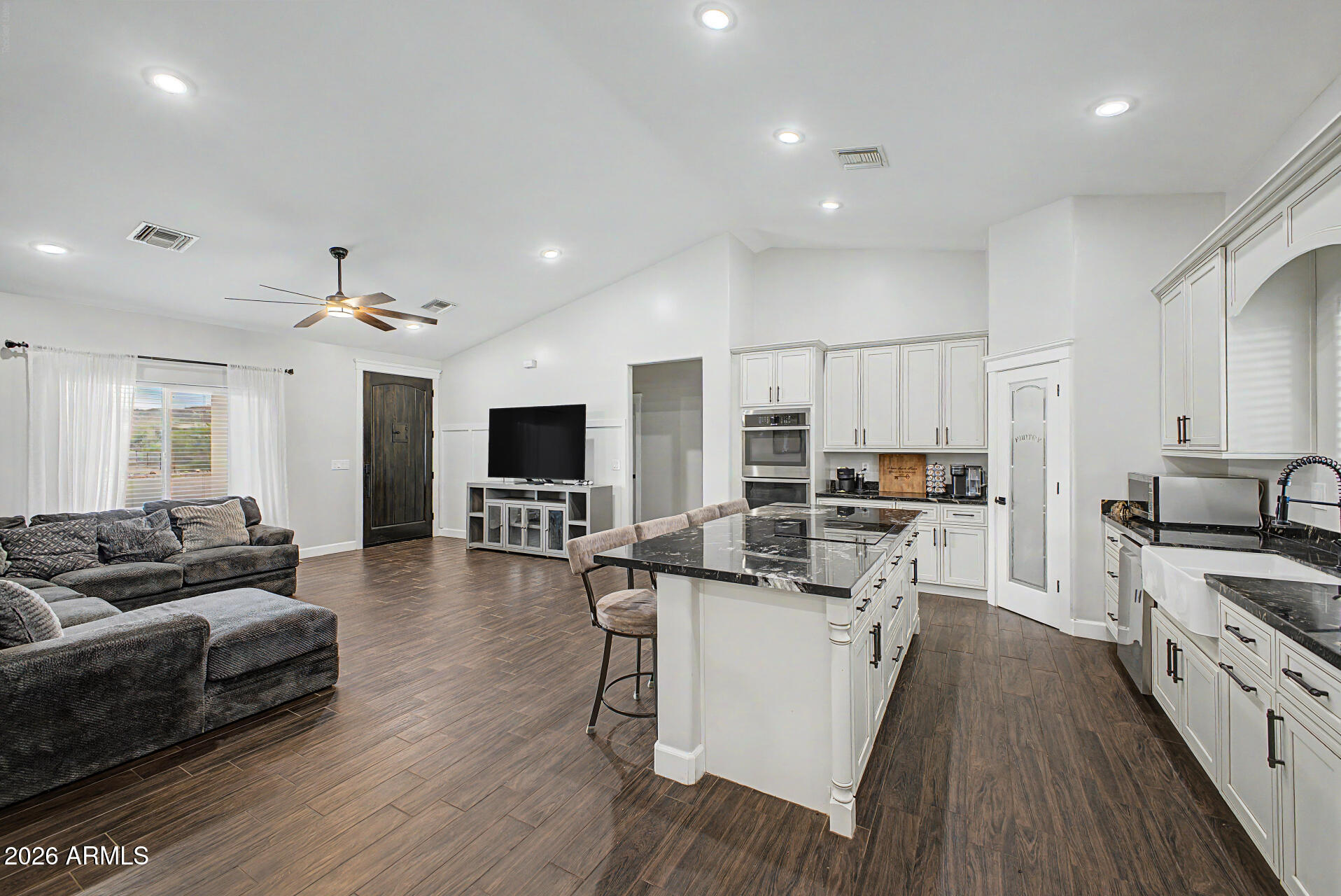 1427 East Whiteley Street Apache Junction, AZ 85119 - Photo 11 of 59 a living room with stainless steel appliances furniture a flat screen tv and a kitchen view
