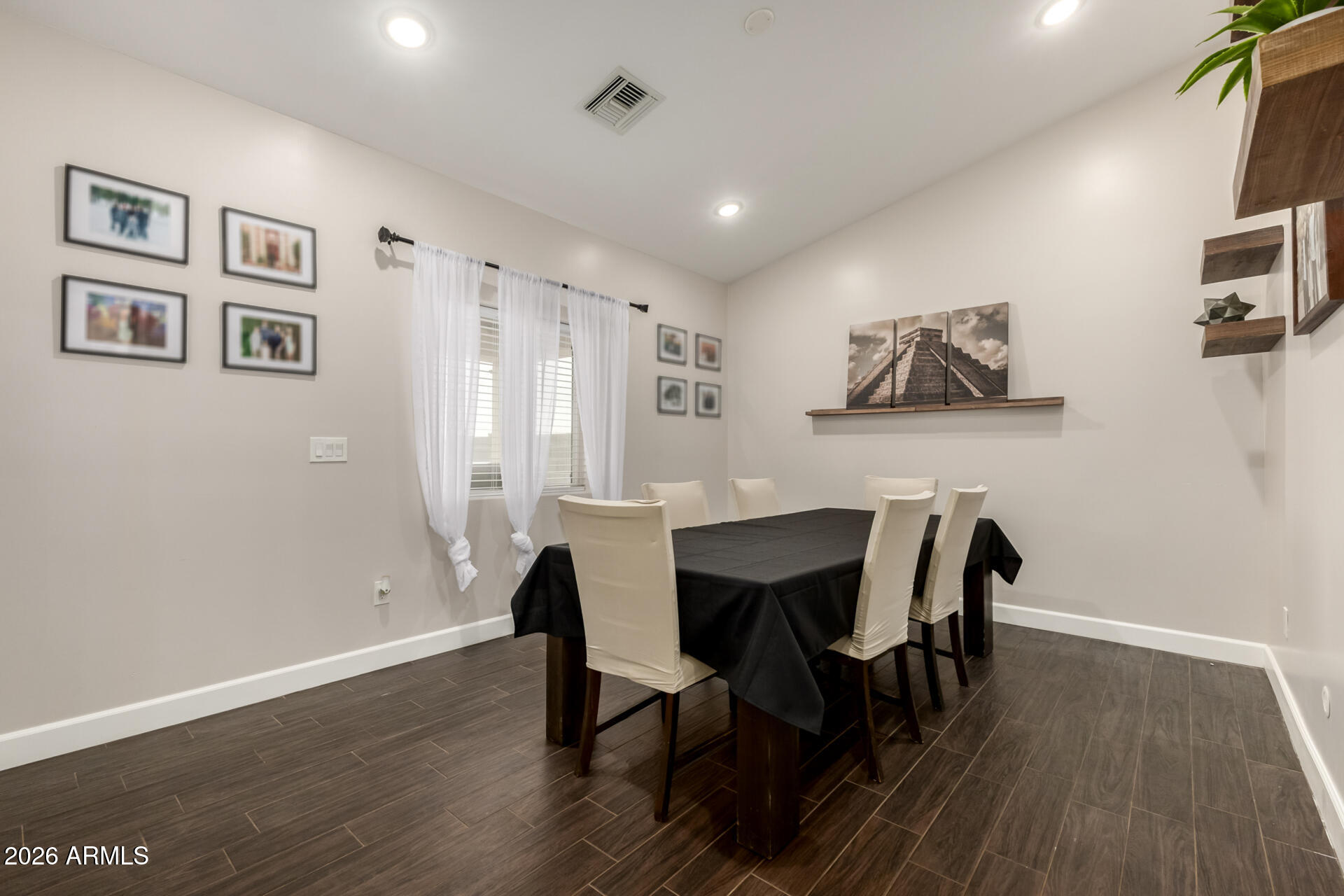 1427 East Whiteley Street Apache Junction, AZ 85119 - Photo 17 of 59 a view of a dining room with furniture and wooden floor