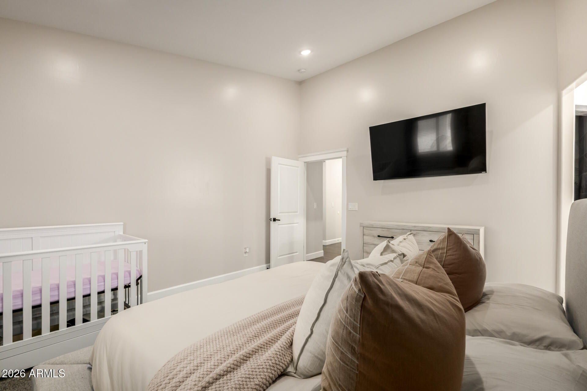 1427 East Whiteley Street Apache Junction, AZ 85119 - Photo 22 of 59 a bedroom with a a bed a flat screen tv and a window