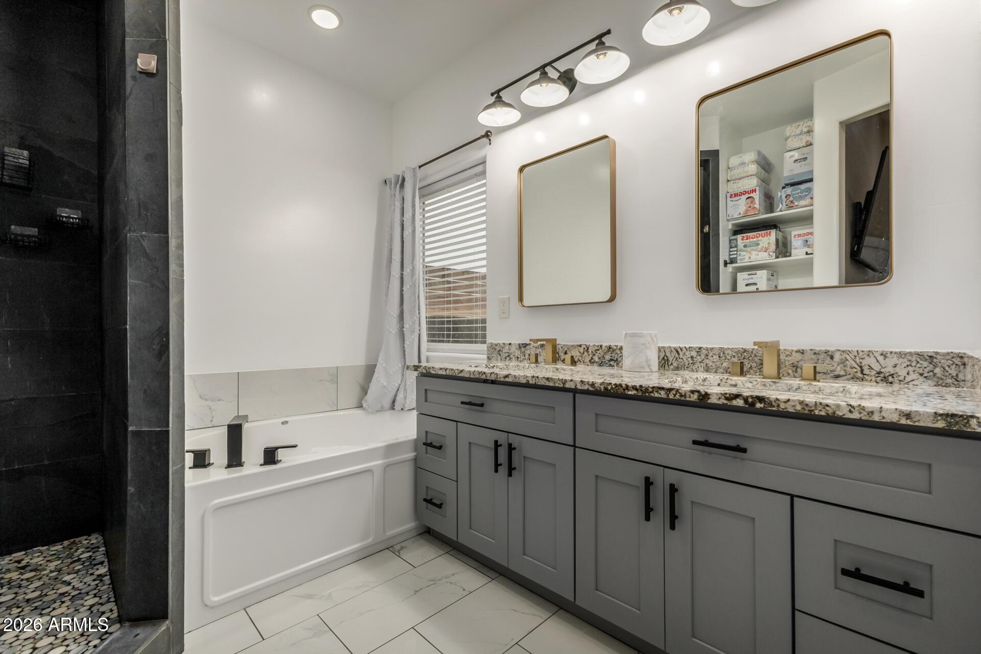 1427 East Whiteley Street Apache Junction, AZ 85119 - Photo 24 of 59 a bathroom with a granite countertop double vanity sink a mirror and a bathtub