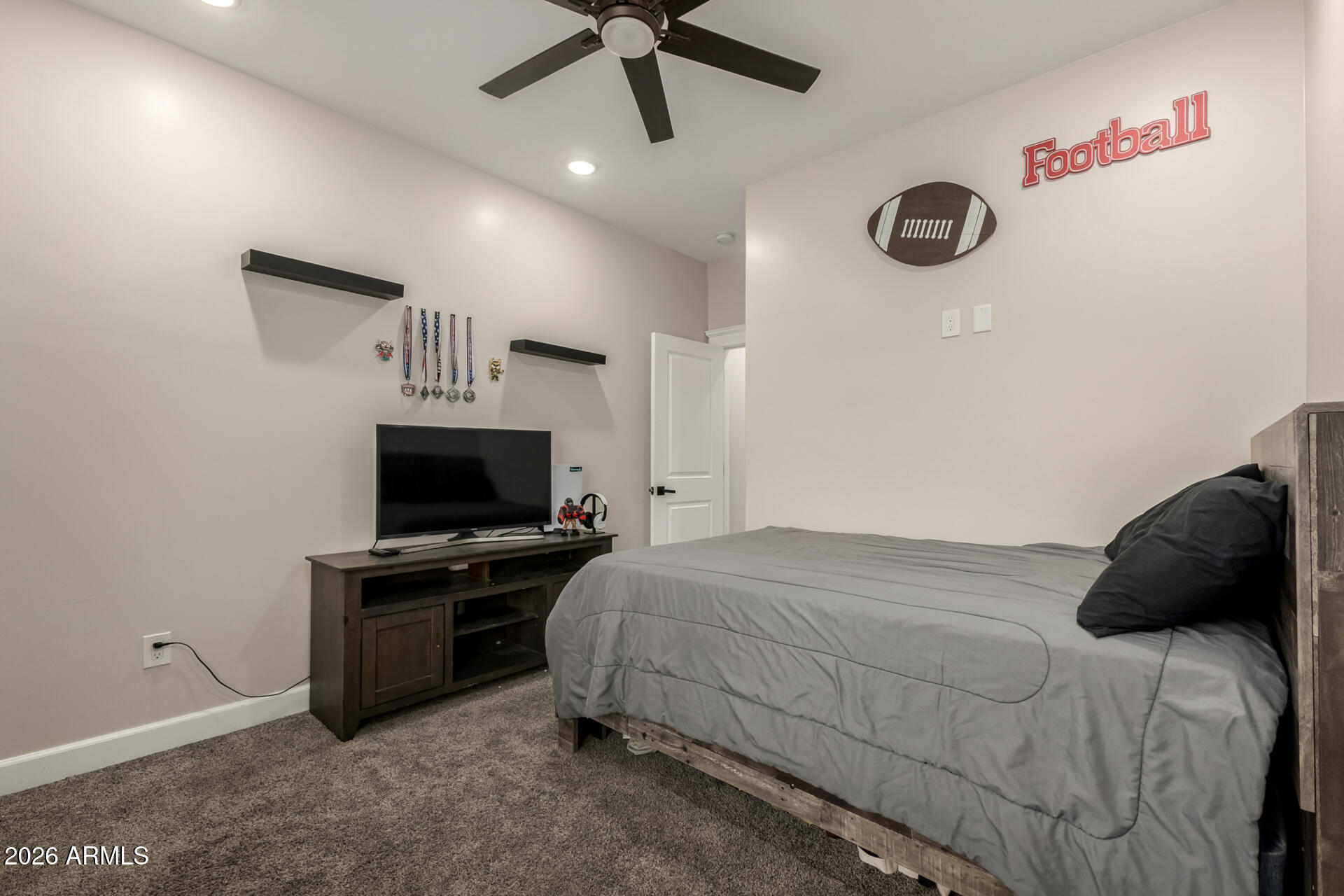 1427 East Whiteley Street Apache Junction, AZ 85119 - Photo 27 of 59 a bedroom with a bed and a flat screen tv