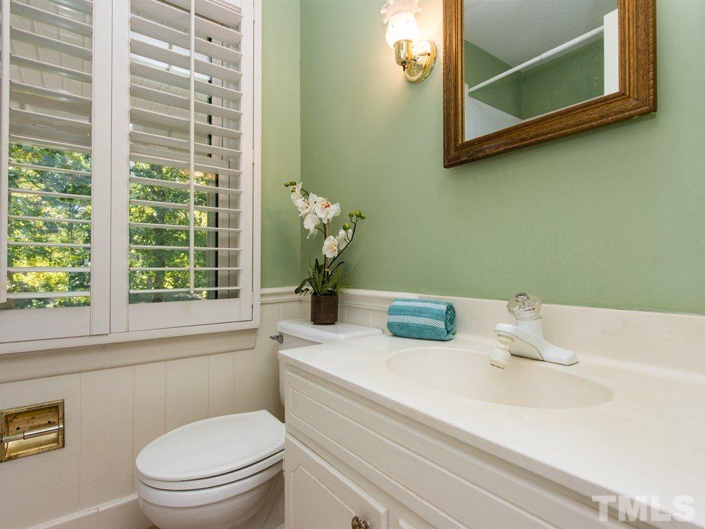 3811 Donna Road Raleigh, NC 27604 - Photo 12 of 25 a bathroom with a sink a toilet and a window