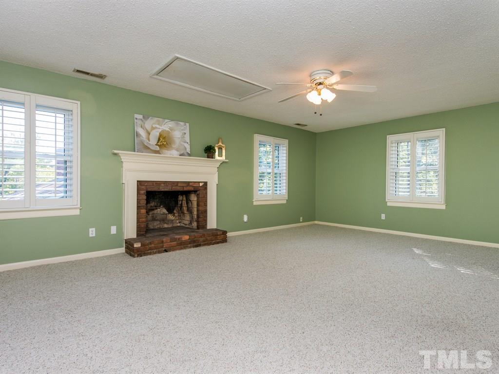 3811 Donna Road Raleigh, NC 27604 - Photo 14 of 25 a view of an empty room with window and fireplace