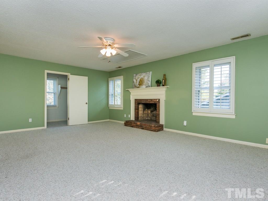 3811 Donna Road Raleigh, NC 27604 - Photo 15 of 25 a view of an empty room with a fireplace and a window
