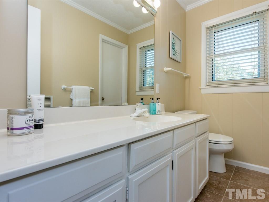 3811 Donna Road Raleigh, NC 27604 - Photo 19 of 25 a bathroom with a granite countertop sink and a mirror