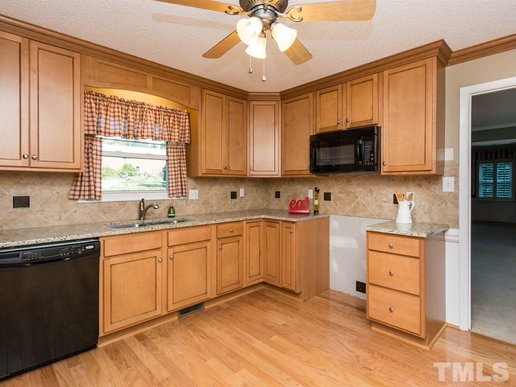 3811 Donna Road Raleigh, NC 27604 - Photo 3 of 25 a kitchen with stainless steel appliances granite countertop a stove top oven a sink dishwasher and a microwave oven with cabinets
