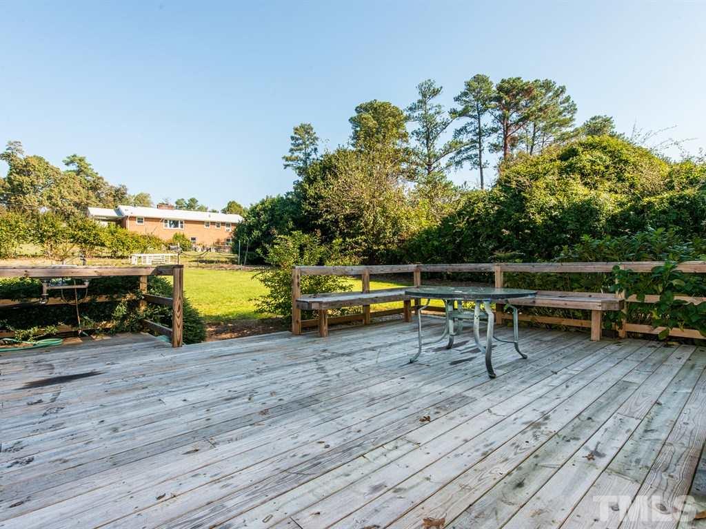 3811 Donna Road Raleigh, NC 27604 - Photo 22 of 25 a view of a chairs and table on the wooden deck